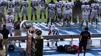 Seattle Seahawks' Michael Bennett Sits During National Anthem _ SI Wire _ Sports Illustrated