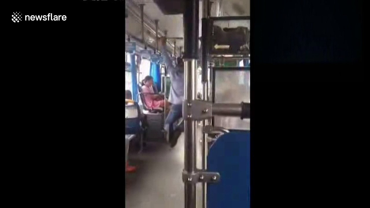 Bus driver performs pull ups at traffic lights