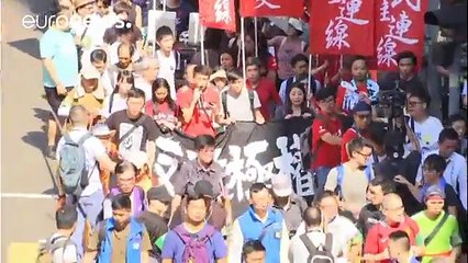 Tens of thousands protest jailing of Hong Kong democracy leaders