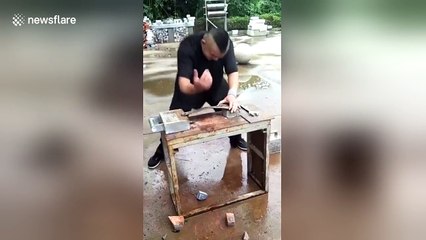 Kung fu master straightens wrench with his bare hands