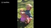 Deaf girl teaches her deaf sister how to sign 'bird' in American Sign Language.