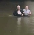 Elderly People Wade Through Houston Floods