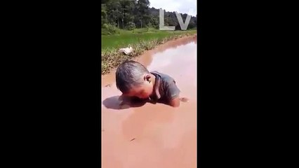 Funny Baby is Sleeping on muddy water