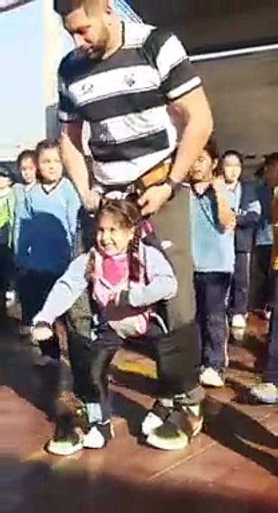 Un prof de sports aide une fillette handicapée à danser pendant une fête de lécole !