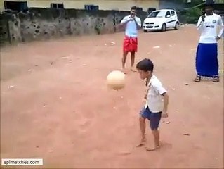 Talented boy playing with football