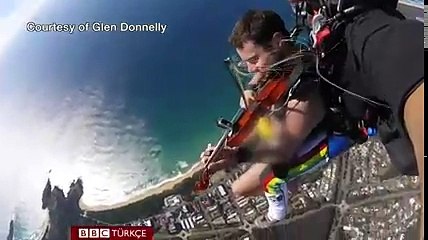 Çıplak bir şekilde keman çalarak uçaktan atlayan adam