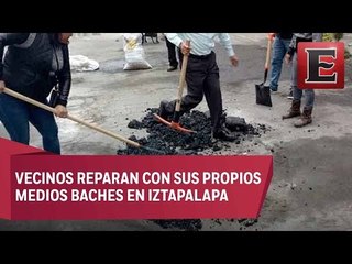 Vecinos de Iztapala salen a reparar baches