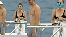 Smitten John Legend can't keep his hands away from bikini-clad wife Chrissy Teigen... as he caresses her peachy posterio