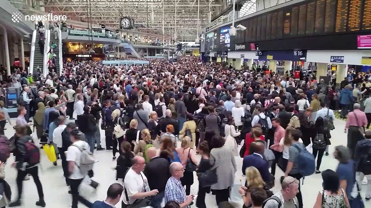 Crowds of people wait for delayed trains at London Waterloo