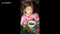 Sleepy toddler tries to eat pancakes