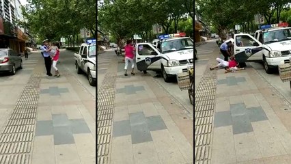 A Shanghai, un policier plaque une femme au sol avec son bébé dans les bras..