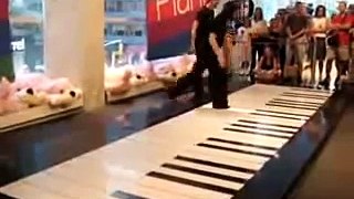 Amazing dancers on the huge piano