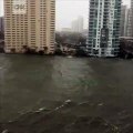 A sky-rise view of downtown Miami shows water overtaking the sea wall as the city braces for the impacts of Hurricane Ir