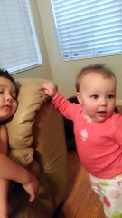 Cute Baby sister tries to wake her big brother funny HD