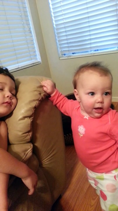 Cute Baby sister tries to wake her big brother funny HD