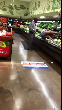 Woman Bathes in Produce at Supermarket