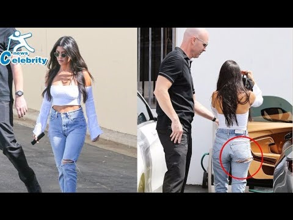 Kourtney Kardashian gives a peek at pert derriere in ripped jeans