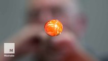 These artists blow air in molten glass to make beautiful Christmas ornaments