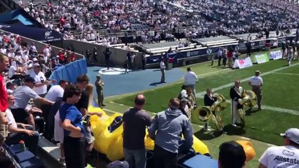 Parachute jumper crash lands into a wall at BYU-Wisconsin game.