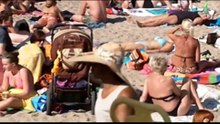 Topless women on beach