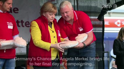 Merkel shows off first aid moves to Stayin' Alive soundtrack