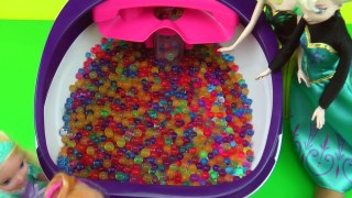 Elsa and Anna toddlers have fun in ORBEEZ ! They slide into colorful water jelly balls!