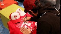 Enrique Iglesias signing hats and shirts