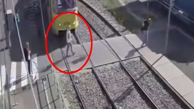 Woman Talking On Her Cell Phone Gets Hit By A Tram