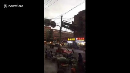 Falling billboard smashes cars in heavy China winds