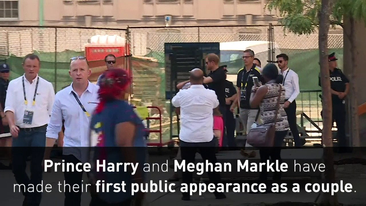 Prince Harry and Meghan Markle hold hands at Invictus