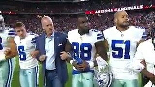 Dallas Cowboys owner Jerry Jones, players lock arms and kneel before national anthem as crowd boos