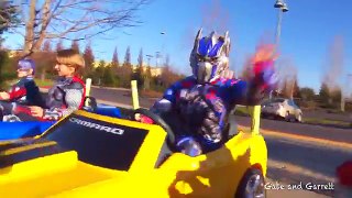 Superheroes Mega Power Wheels Race 3! 5 Ride On Cars! | Gabe and Garrett