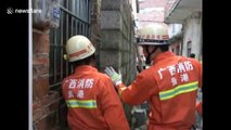 Firefighters free Chinese boy wedged tight between walls