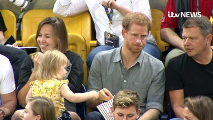 Prince Harry shares his popcorn with little girl