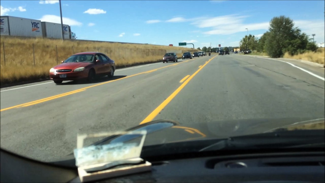 Old Man on Scooter Rides Down Middle of Street