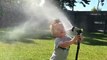 Kid Sprays Face With Water Hose
