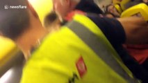Flight passenger filmed getting aggressive man in choke hold