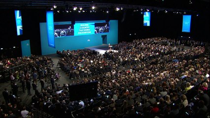 Theresa May coughs and jokes way through speech
