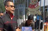 Red shirt leader Jamal Yunos smashes crates of beer at SUK entrance