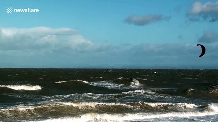 Kitesurfers in UK's northwest take flight in gusty conditions