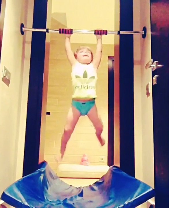 Toddler Performs Pull Ups on Exercise Bar