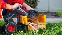 Bruder Toy Trucks in Action: Kid Playing Logging Tror and Truck Outside
