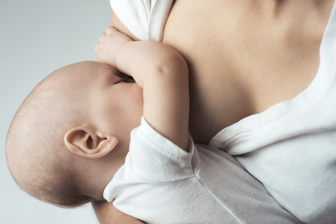 breastfeeding baby and mother at room