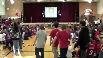 Soldier Suprises Children at Veterans Day Celebration