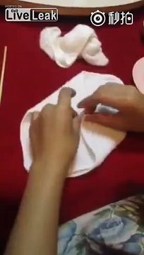 Woman folds towels into genitals