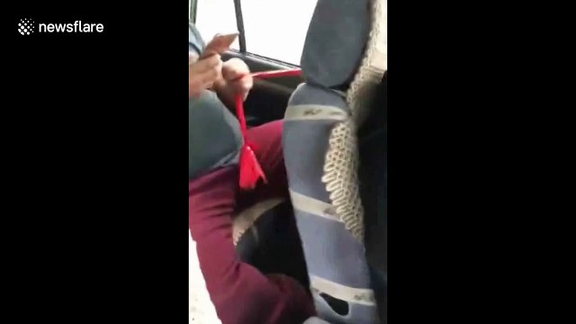 Passenger operates windscreen wipers manually with cloth