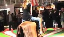 Girl rides mechanical Bull