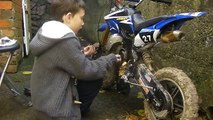Liam (aged 10) fits a clutch on a mini dirt bike