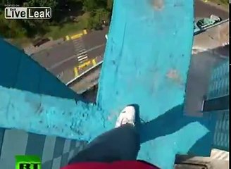 GIRL WITH NICE RACK WALKS ACROSS CONCRETE BEAMS ON ROOF OF BUILDING