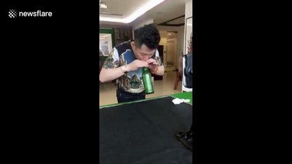 Kung fu master blows hole in bottom of glass bottle